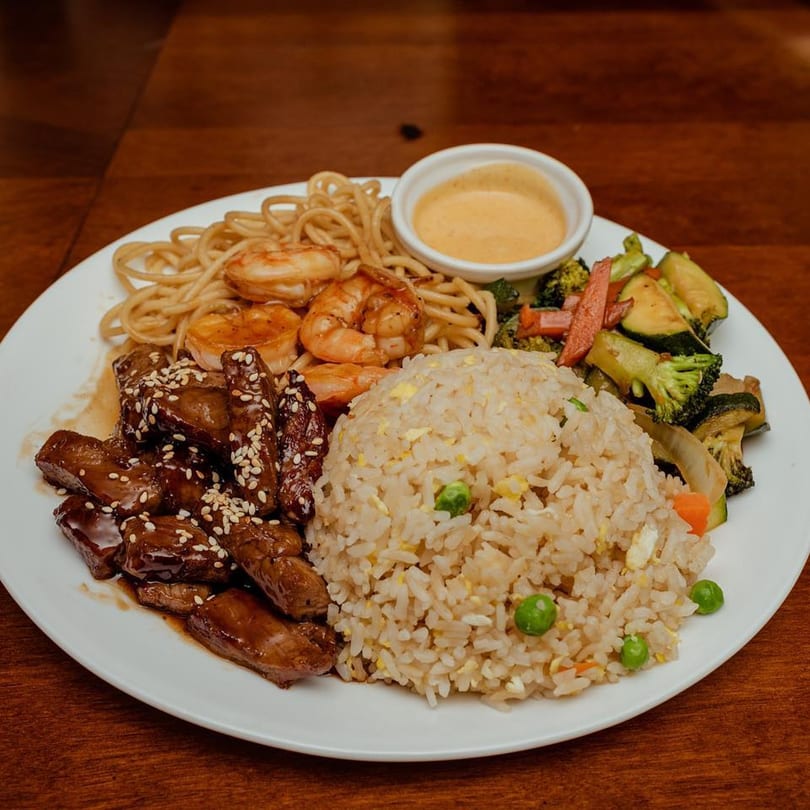 Oishii Hibachi Grill's hibachi dinner with steak, shrimp, noodles, fried rice, and mixed vegetables.